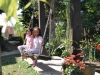 Little Thai girls playing on a swing in Bueng Farm Pai